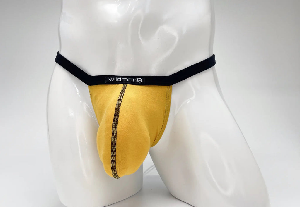 WildmanT gold modal micro thong with a prominent big boy pouch, featuring black waistband and contrast stitching.
