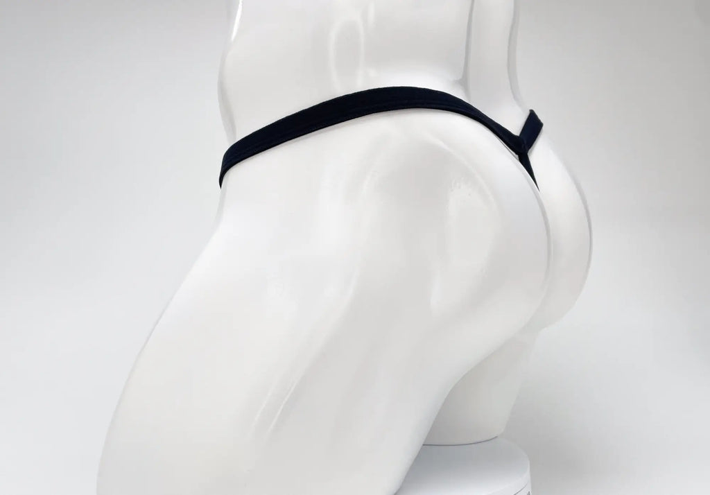 A dark purple WildmanT modal micro thong on a white mannequin, showing the rear T-back style.