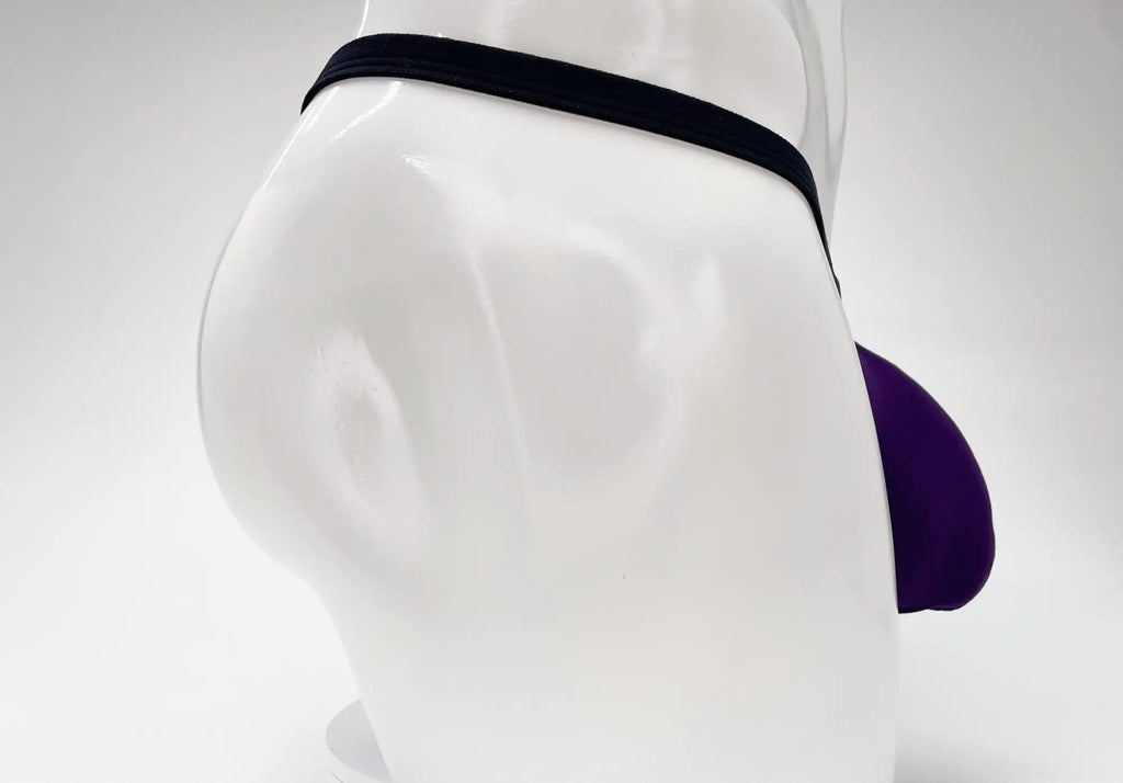 WildmanT purple modal micro thong with a prominent pouch, displayed on a white mannequin torso.