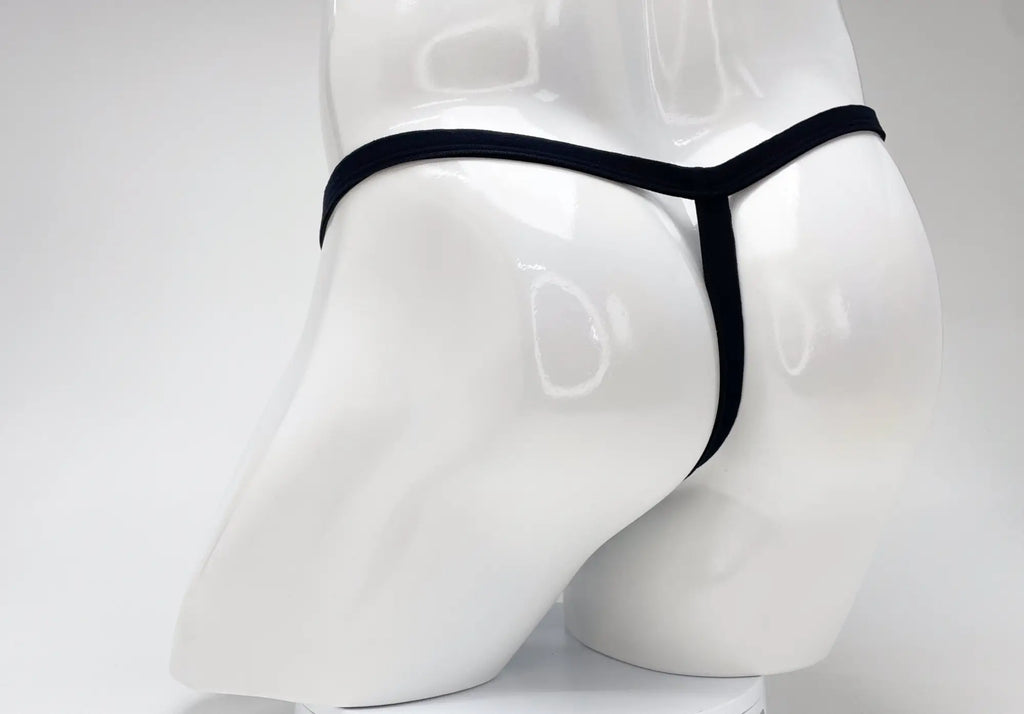 Back view of a WildmanT purple modal micro thong with a thin black waistband on a white mannequin.