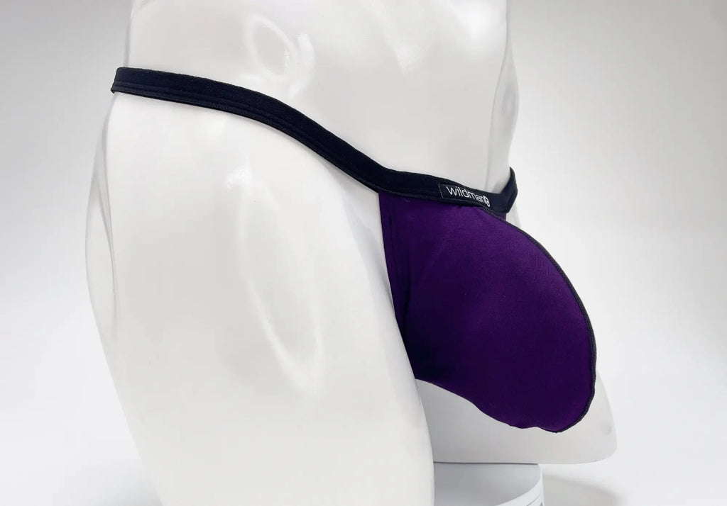 Purple WildmanT modal micro thong with a prominent pouch, black trim, and "WildmanT" logo on a white mannequin.