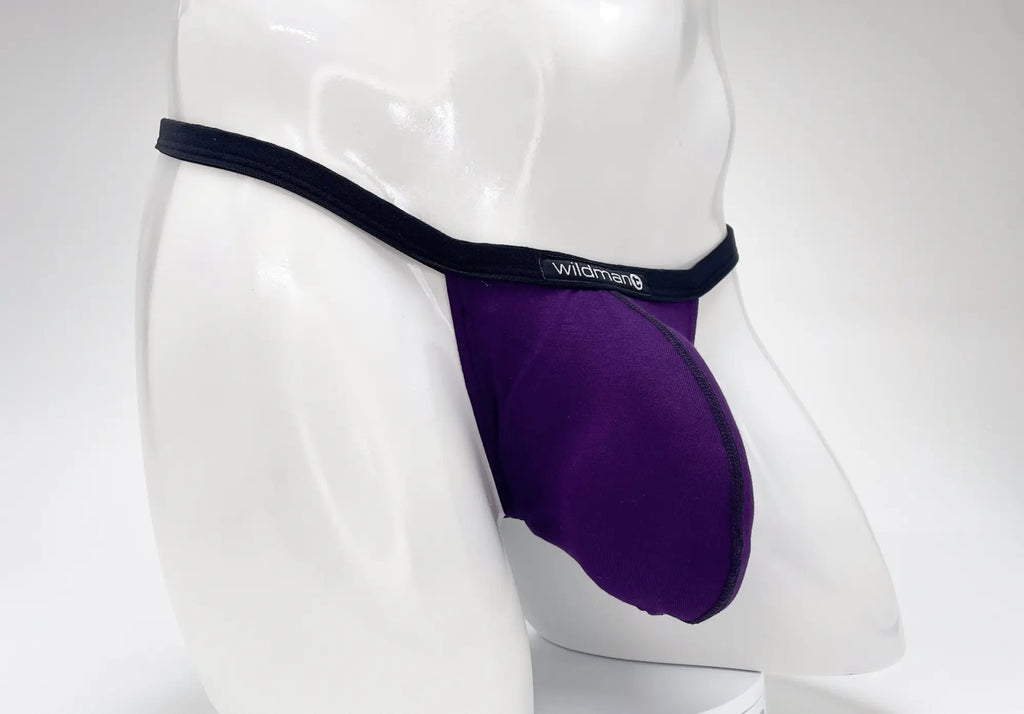 Purple WildmanT modal micro thong with a prominent big boy pouch, featuring a black waistband and logo label.