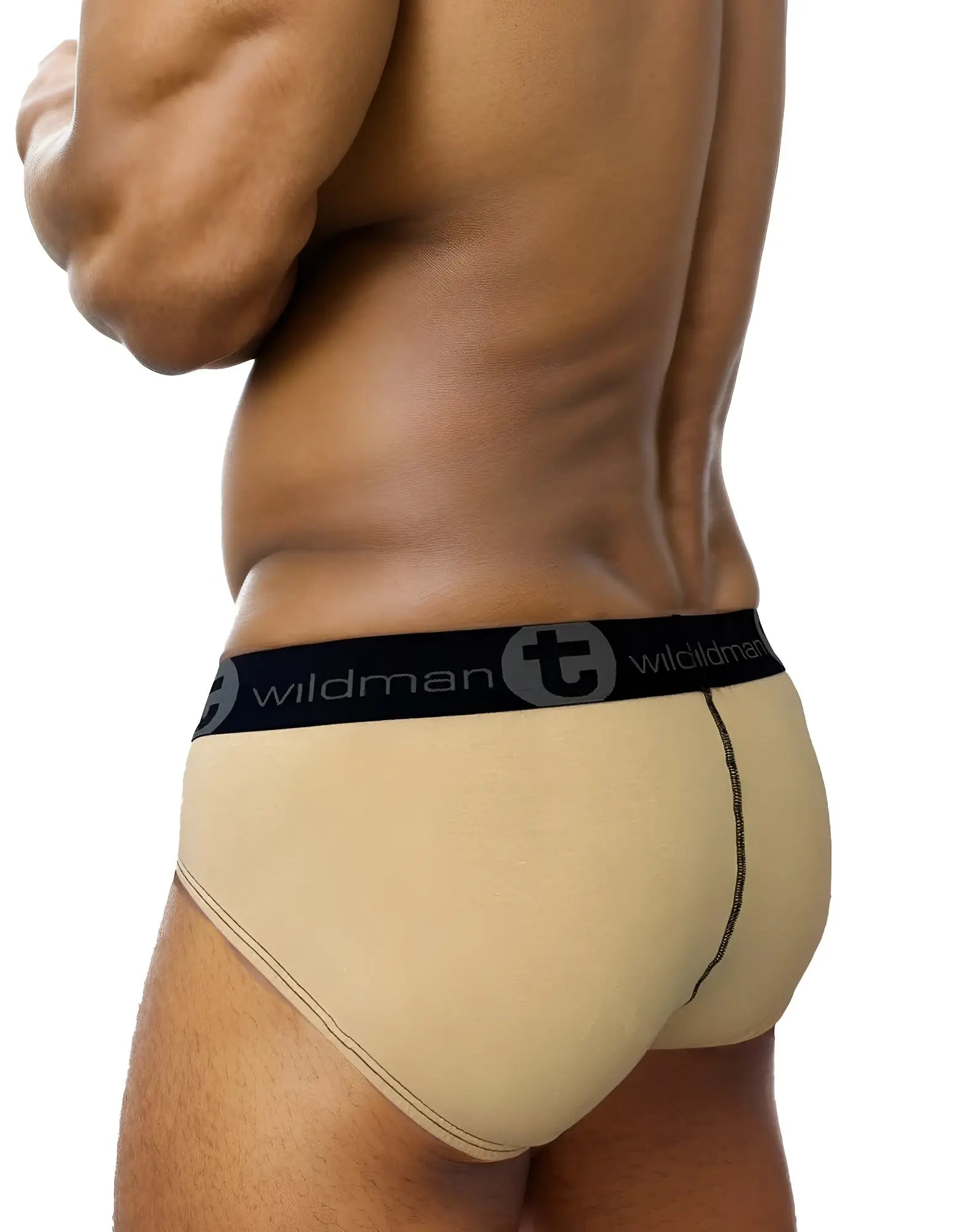 Tan WildmanT cotton brief with a black branded waistband and contrasting black center seam detail, viewed from the side.