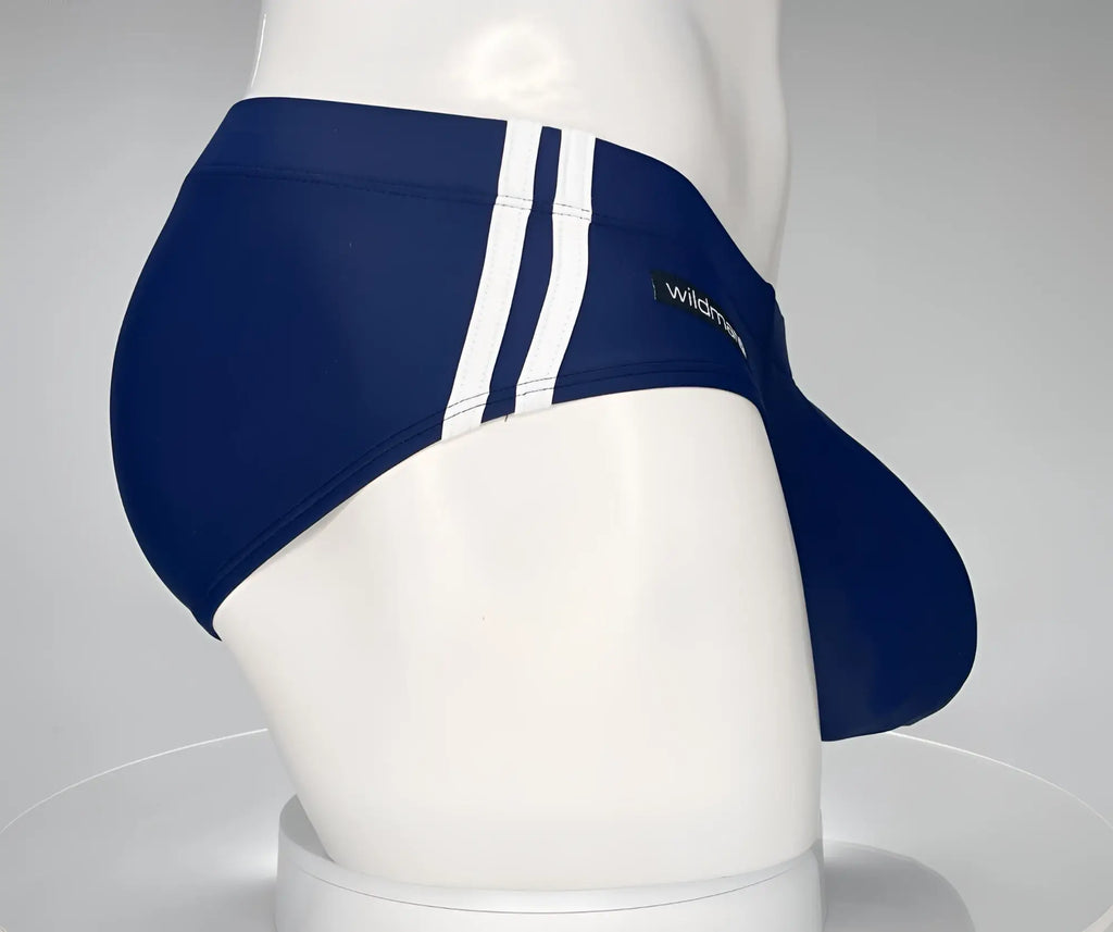 Navy blue swim brief with double white side stripes and a prominent contoured front pouch on a mannequin.