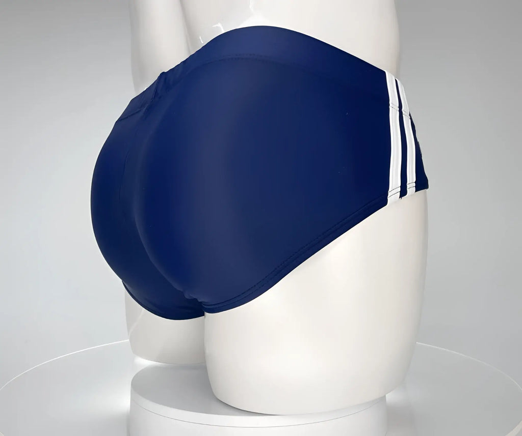 Navy blue swim brief with two vertical white side stripes on a white mannequin.