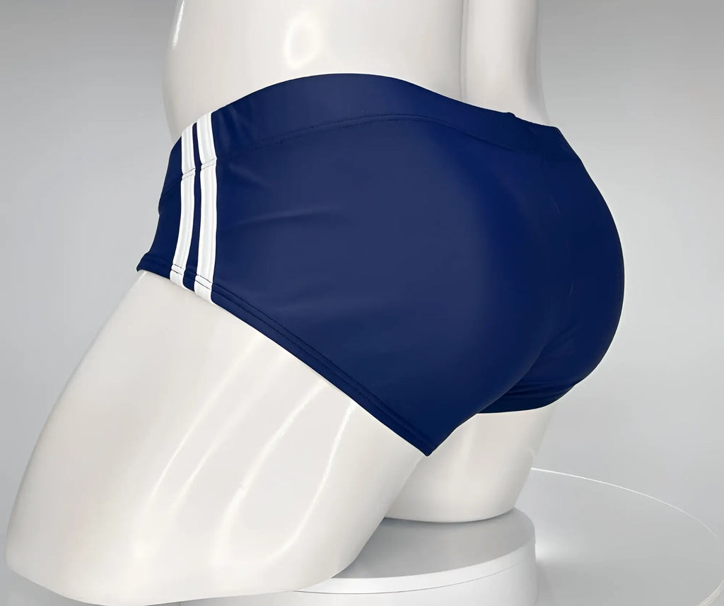 Navy blue WildmanT swim brief on a mannequin, featuring two white vertical stripes on the side.