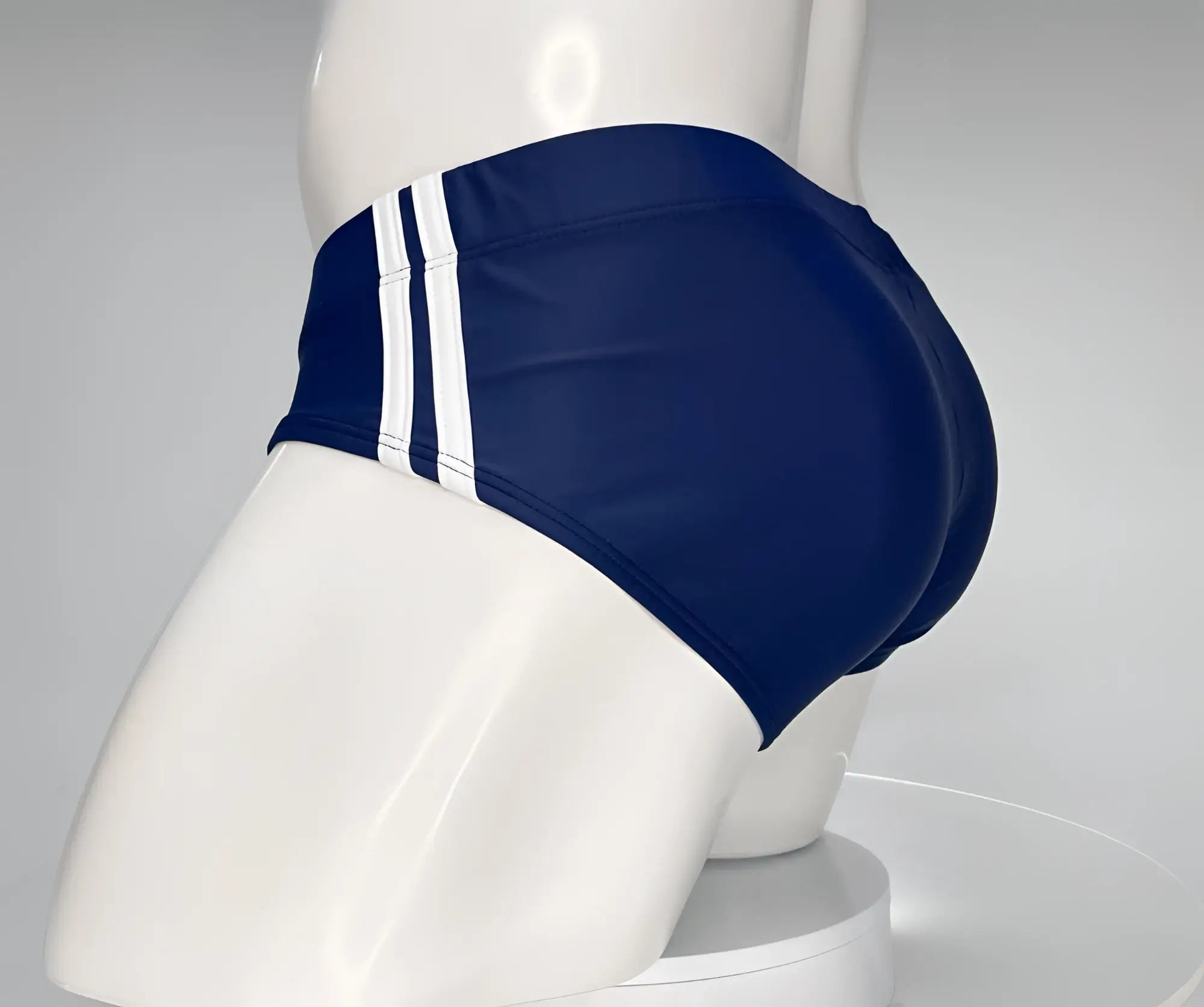Navy blue swim brief with two vertical white side stripes on a white mannequin.
