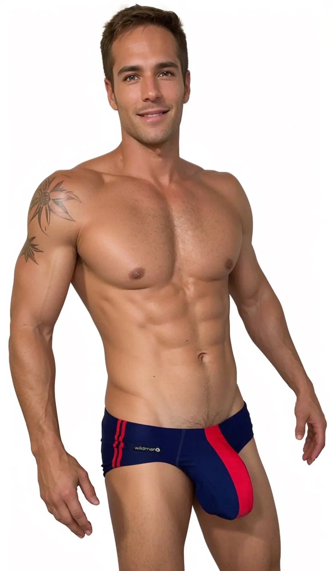 Muscular man wearing a navy and red WildmanT swim brief with a prominent contoured pouch and side stripe detail.