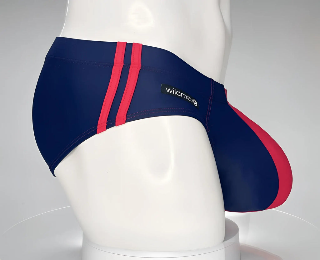 Navy and red WildmanT swim brief with side stripe detail and a contoured pouch on a white mannequin.