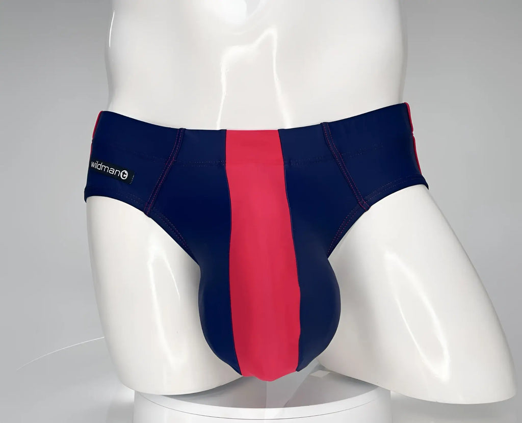 WildmanT navy and red swim brief with a prominent center red panel and white branded tag on a mannequin.