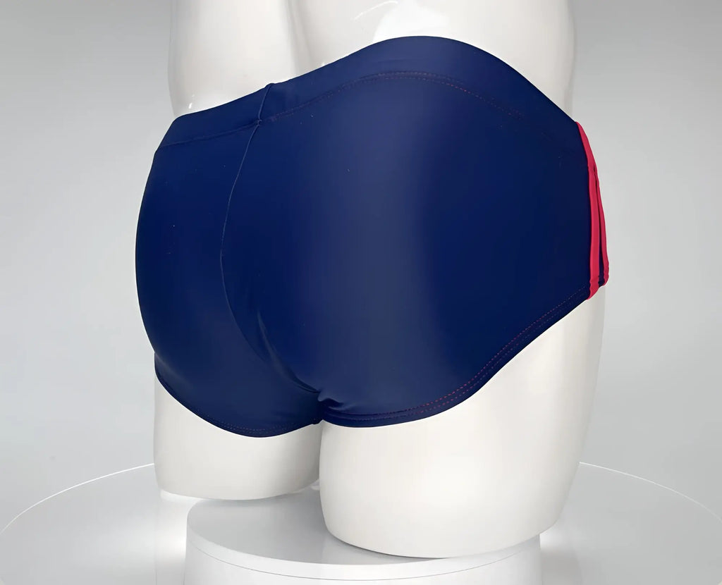 Navy blue swim brief with red side stripes and red stitching, worn on a white mannequin.