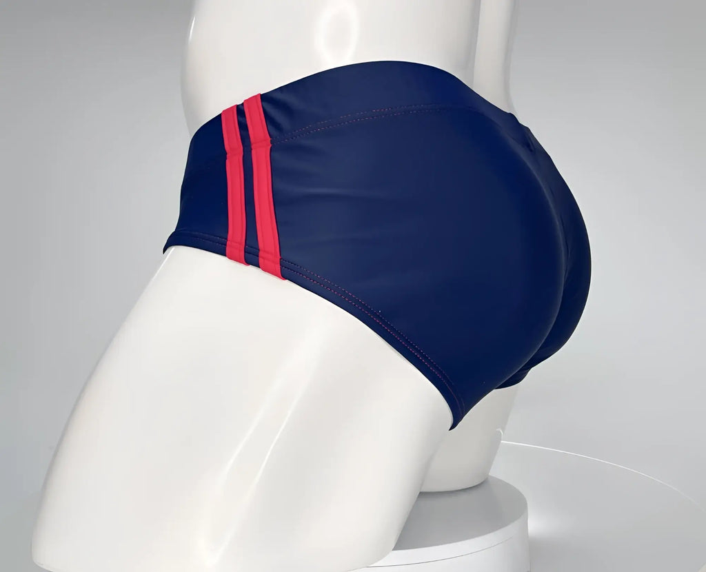 Navy blue swim brief with two red side stripes on a white mannequin.