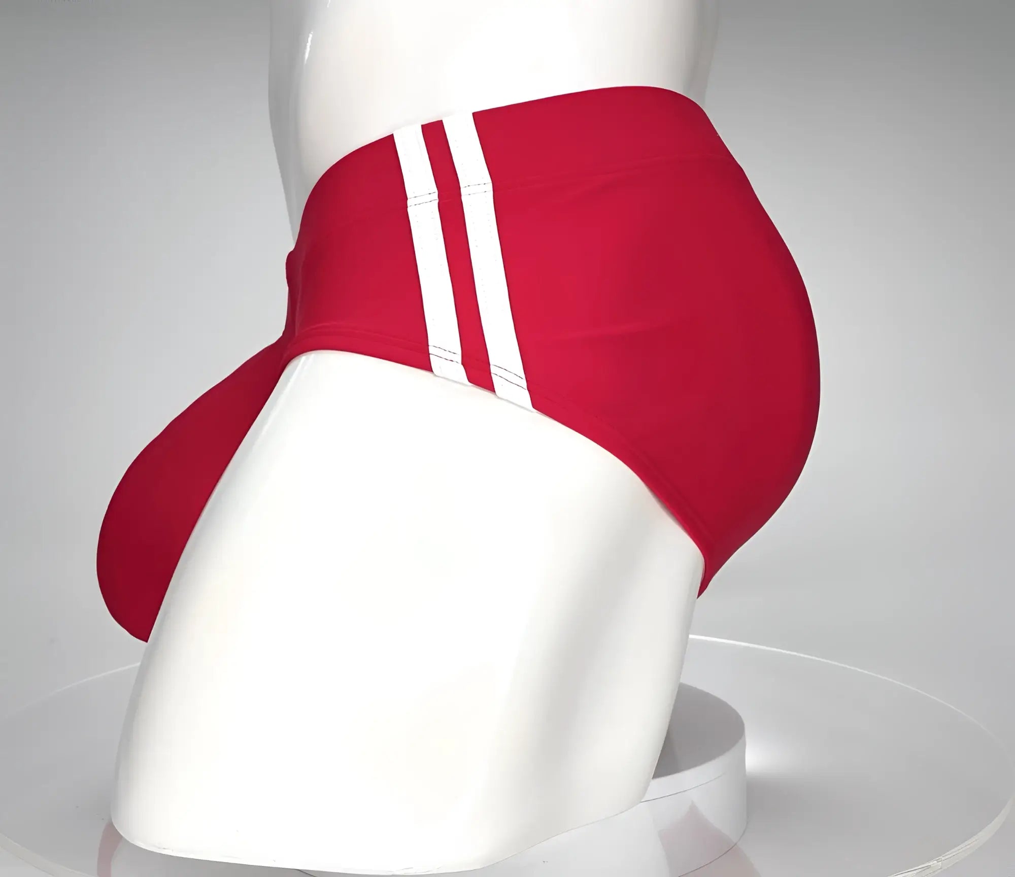 Red WildmanT swim brief with white side stripes and a contoured front pouch, displayed on a mannequin.