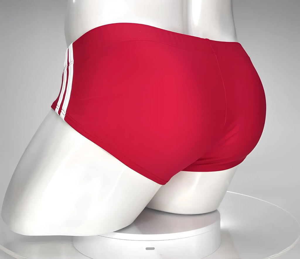Red swim brief on a mannequin, featuring two white side stripes, viewed from the back.