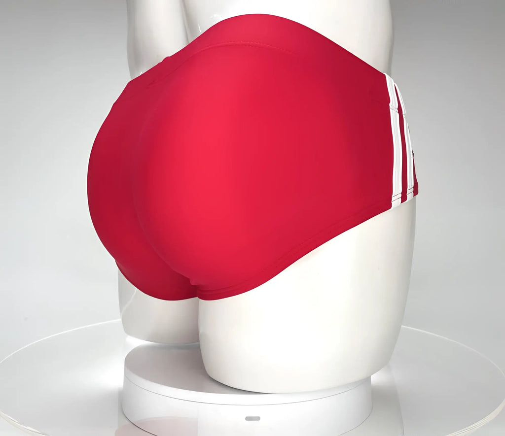 Red WildmanT swim briefs featuring two vertical white stripes on the side, displayed on a white mannequin.