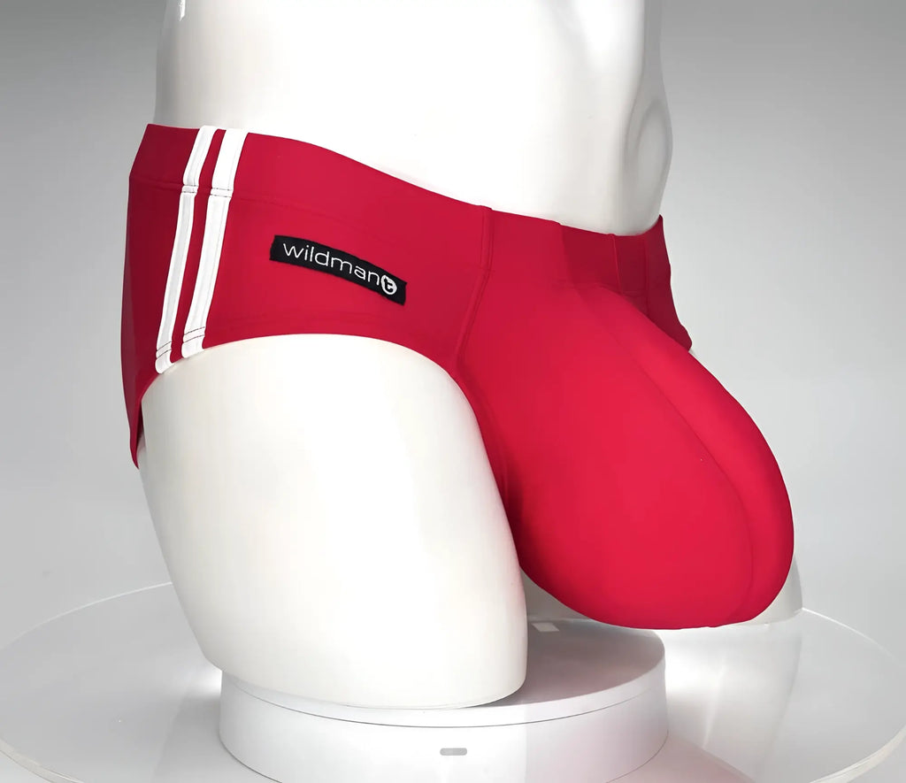 Red WildmanT swim brief with white side stripes and a prominent contoured pouch on a white mannequin torso.