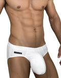 White WildmanT swim brief with contoured pouch and side logo label on a fit, shirtless male torso.