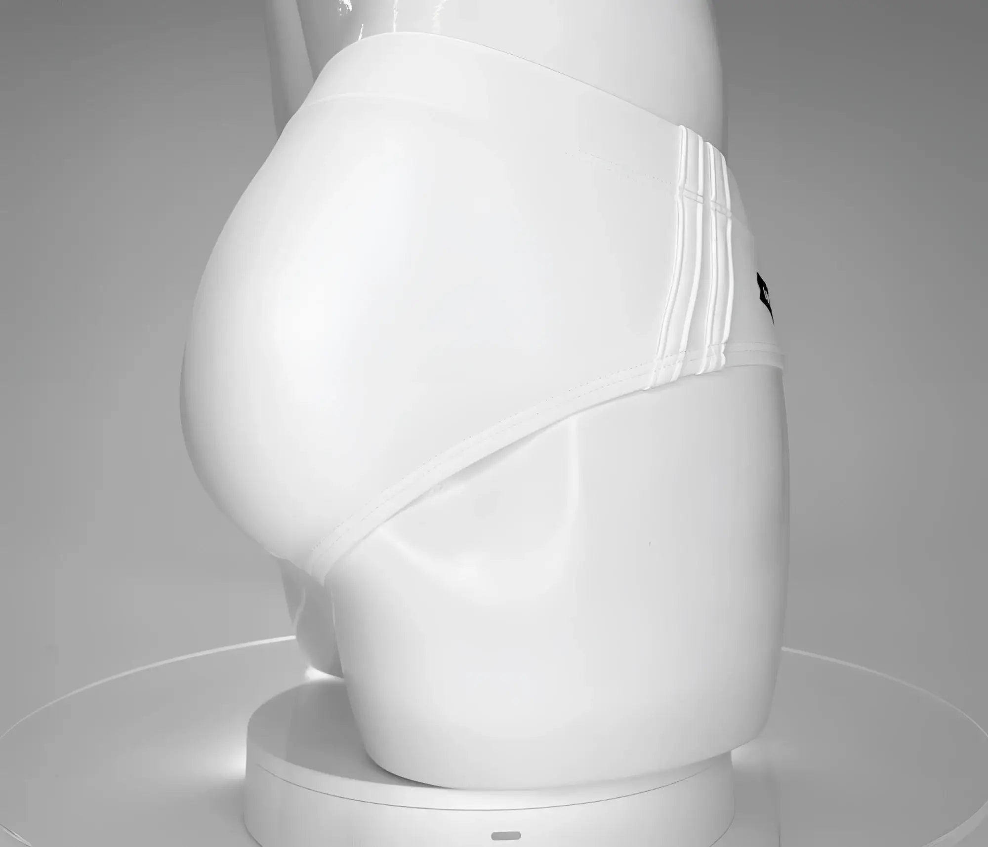 Side profile of white WildmanT swim brief on a mannequin, featuring triple-striped side panel details.