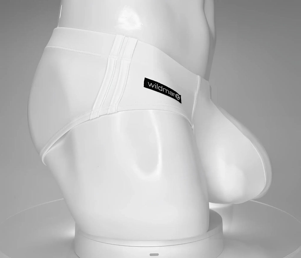 White WildmanT swim brief on a mannequin, featuring double side stitching and a black logo patch.