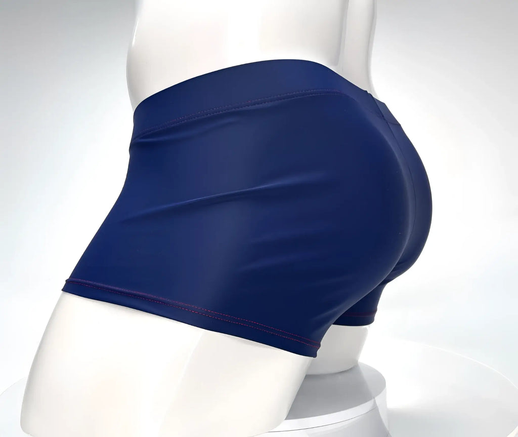 Navy blue square-cut swim trunks with contrast red stitching on a white mannequin torso.