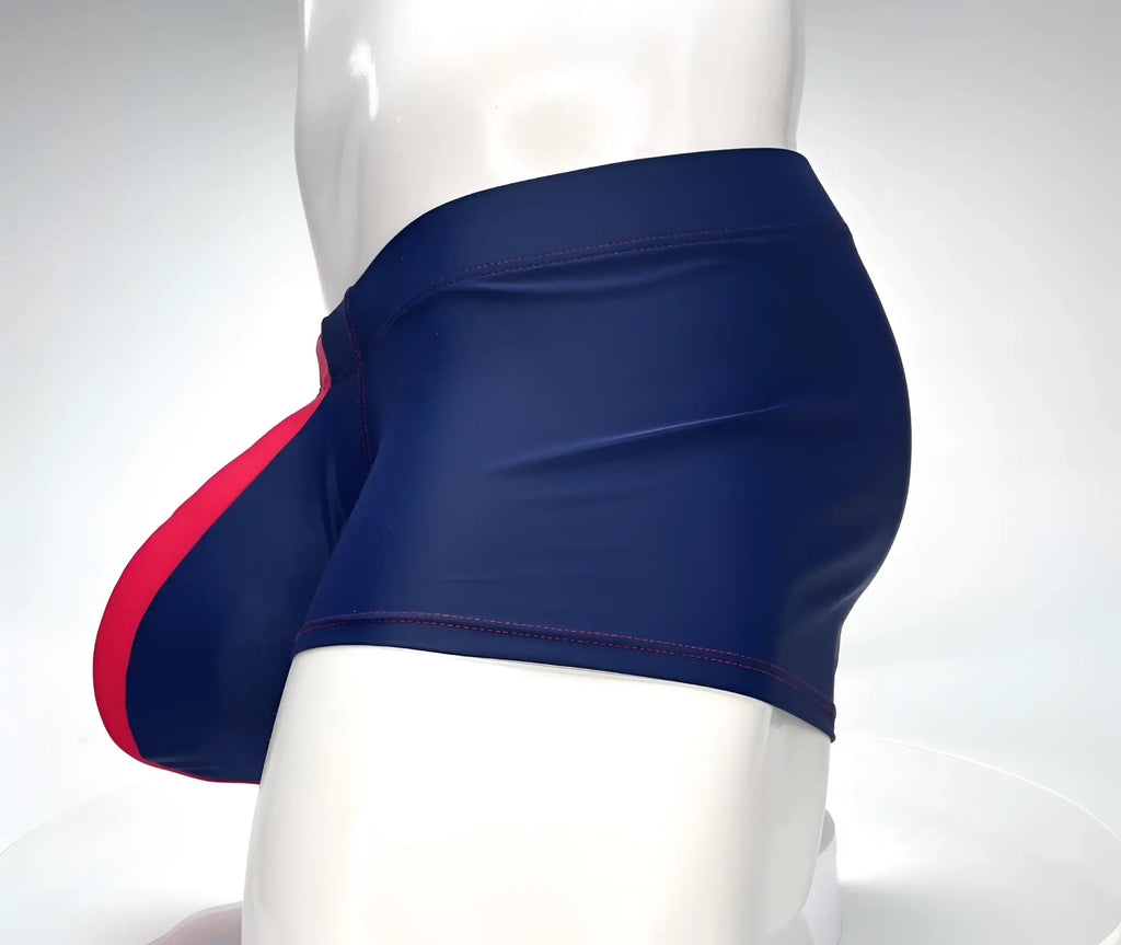 Navy blue square-cut swim trunks with a bright red pouch detail and matching red contrast stitching on a white mannequin.