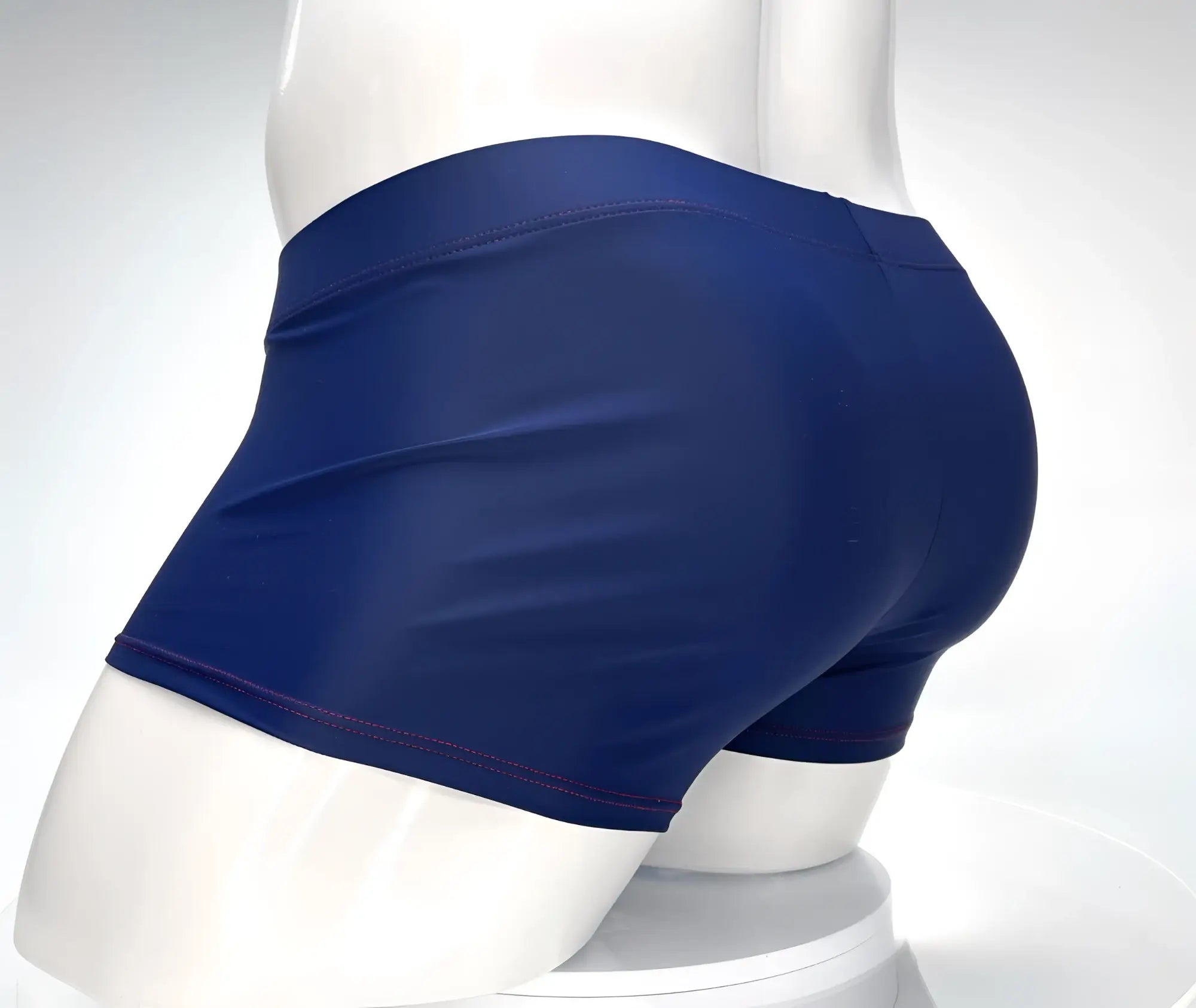 WildmanT navy square-cut swim trunks with red contrast stitching, shown on a white mannequin.