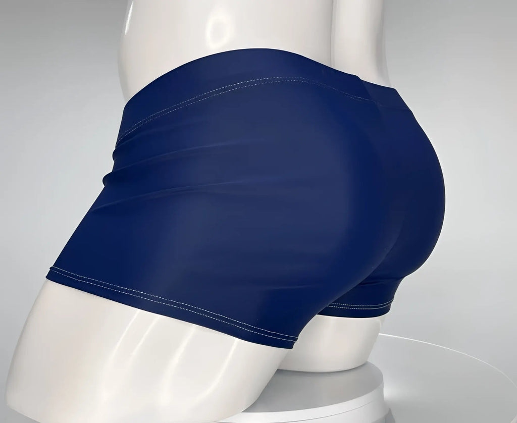 Navy blue square-cut swim trunks with white contrast stitching on a mannequin, side view.