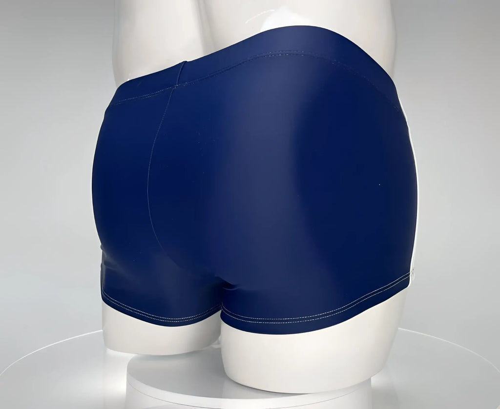 Navy blue square-cut swim trunks with white side trim, displayed on a white mannequin.