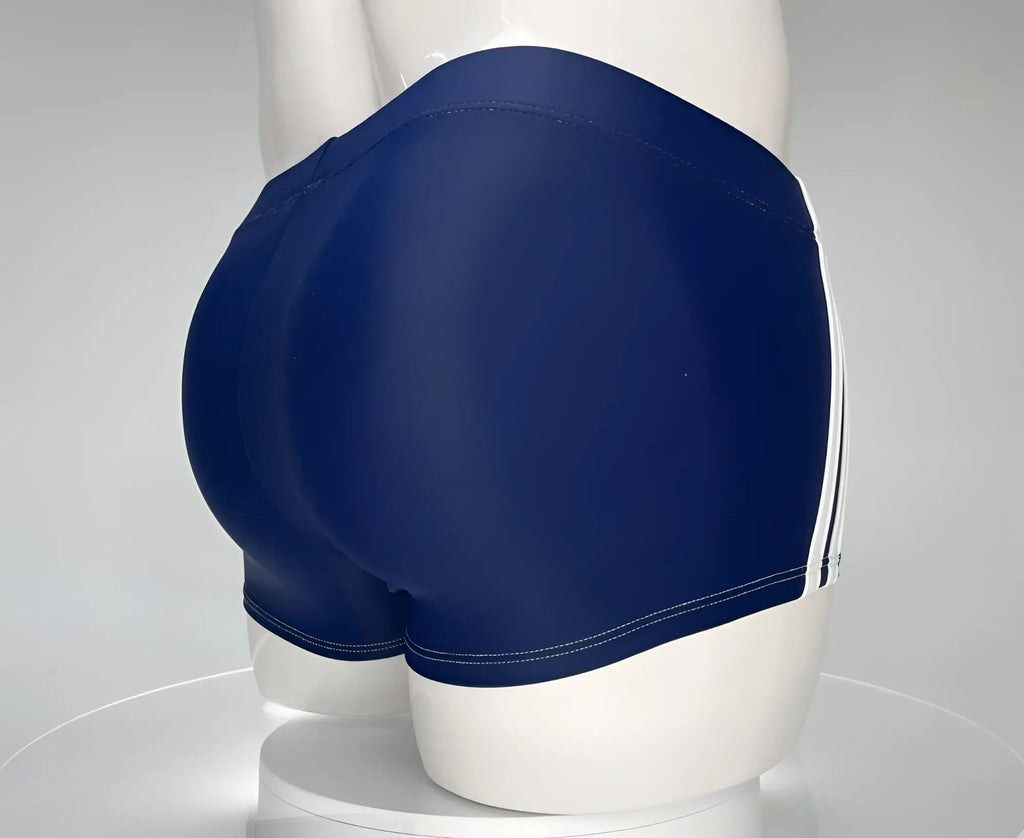 WildmanT navy blue square-cut swim trunks on a mannequin, featuring dual white side stripes and white stitching.