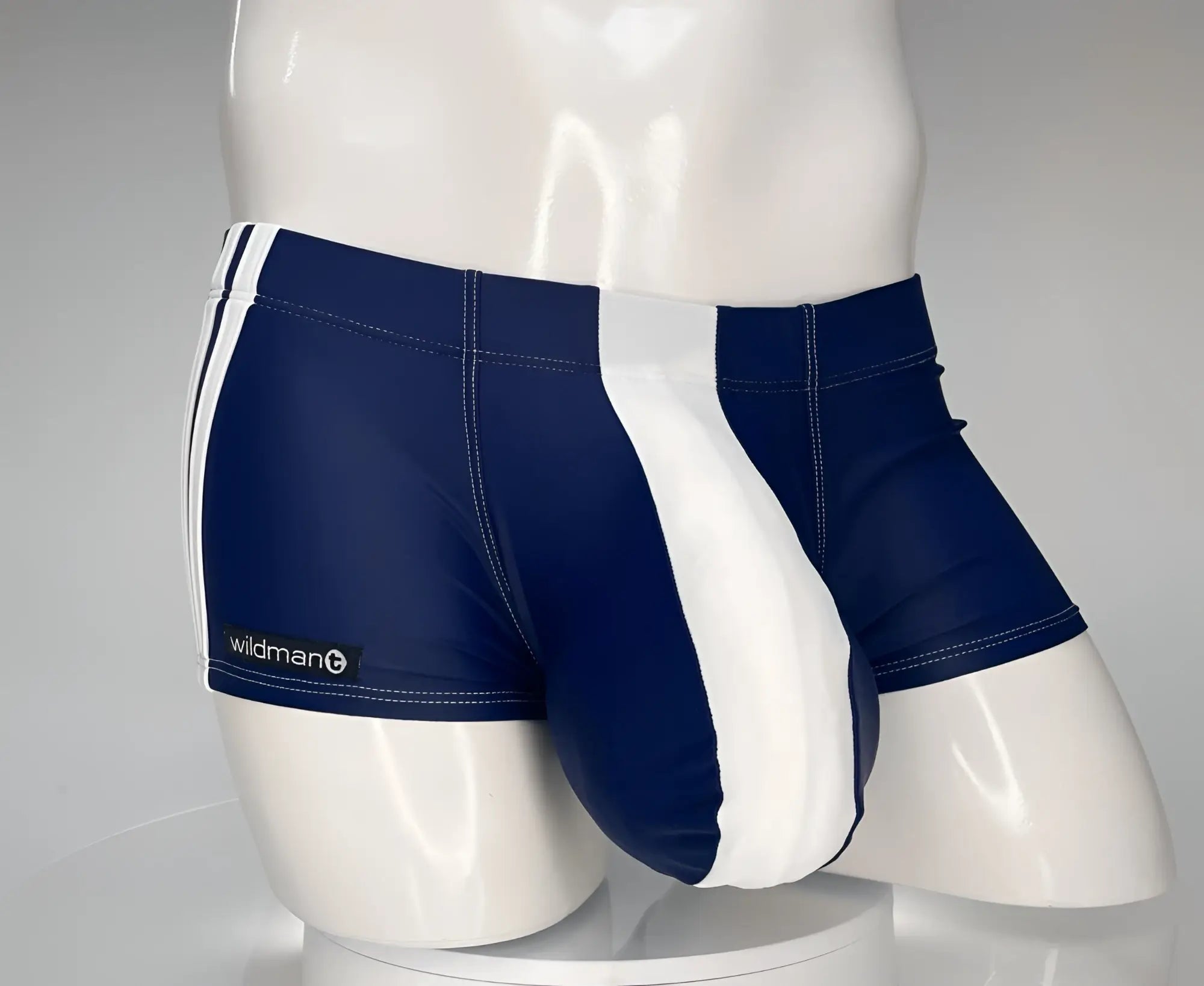 Navy blue and white square-cut swim trunks with white side stripes and a prominent contoured front pouch.