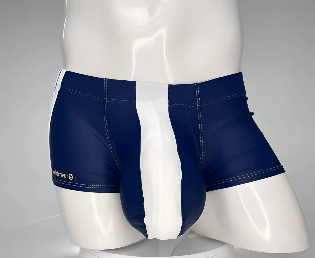 WildmanT navy and white square-cut swim trunks with a prominent center pouch on a white mannequin torso.