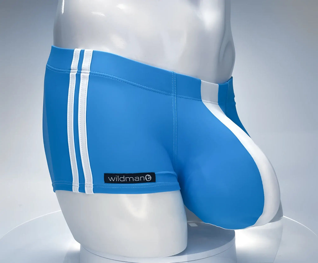 Teal and white WildmanT square-cut swim trunks with double side stripes and a contoured front pouch on a mannequin.