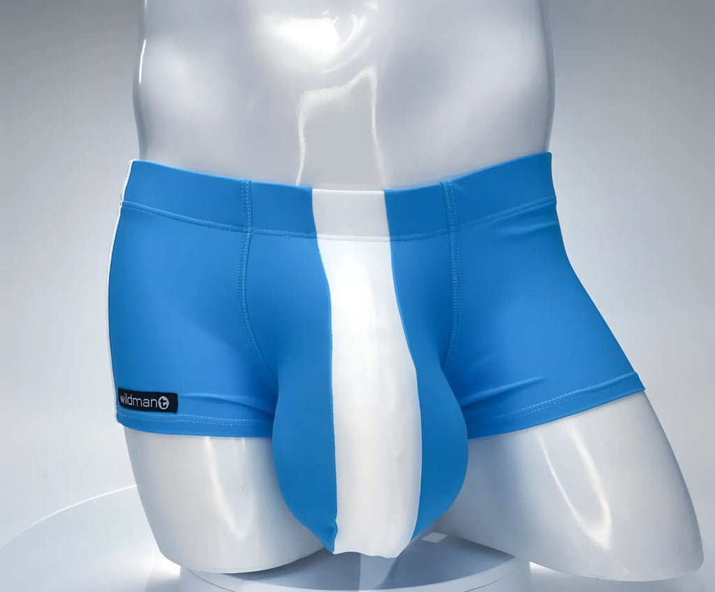 WildmanT teal and white square-cut swim trunks with a prominent center pouch on a mannequin torso.