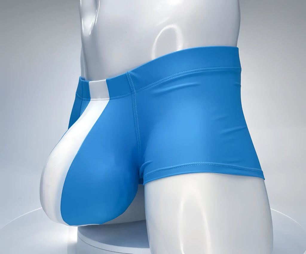 Teal and white square-cut swim trunks with a prominent contoured front pouch on a white mannequin torso.