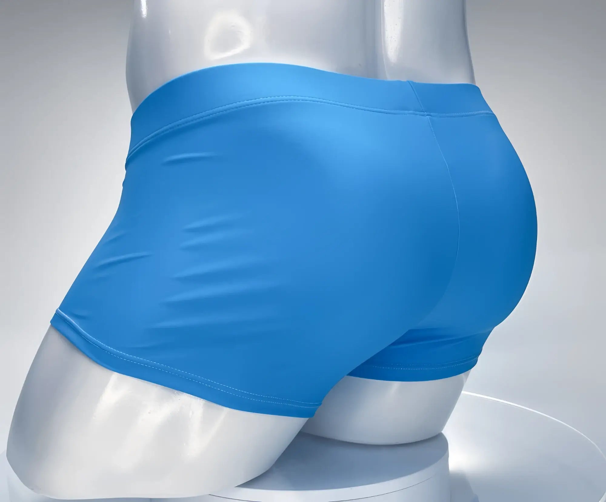 Teal square-cut swim trunks on a white mannequin torso, back view.