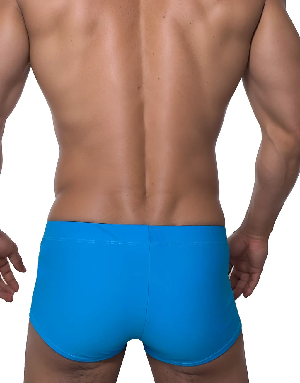 Back view of a man wearing solid teal square-cut swim trunks against a white background.