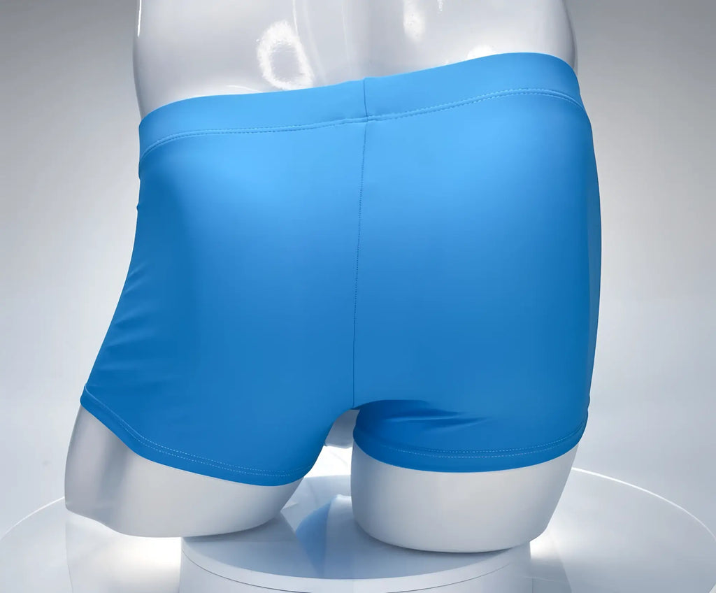 WildmanT square cut swim trunks in solid teal on a white mannequin torso, back view.