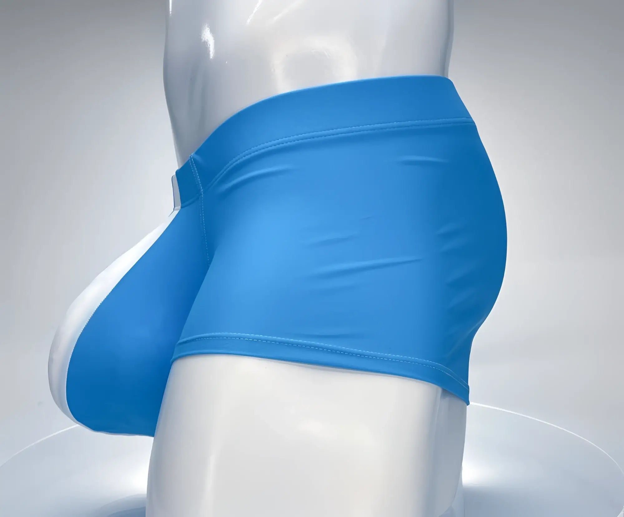 Teal and white swim square cut trunks with a contoured pouch worn on a white mannequin.