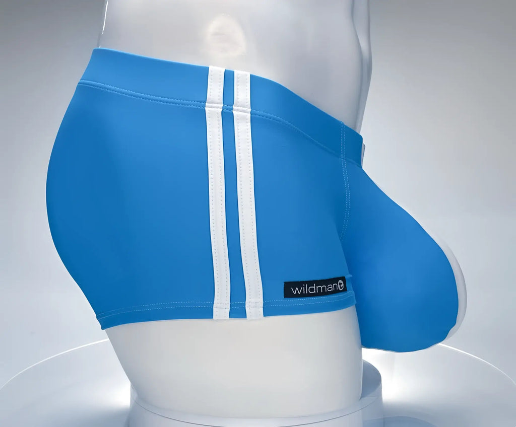 Teal square-cut swim trunks with two white side stripes and a "wildmanT" logo tag, worn on a white mannequin torso.