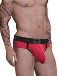 WildmanT red mesh Big Boy pouch brief with black trim and a branded black elastic waistband on a tattooed model.