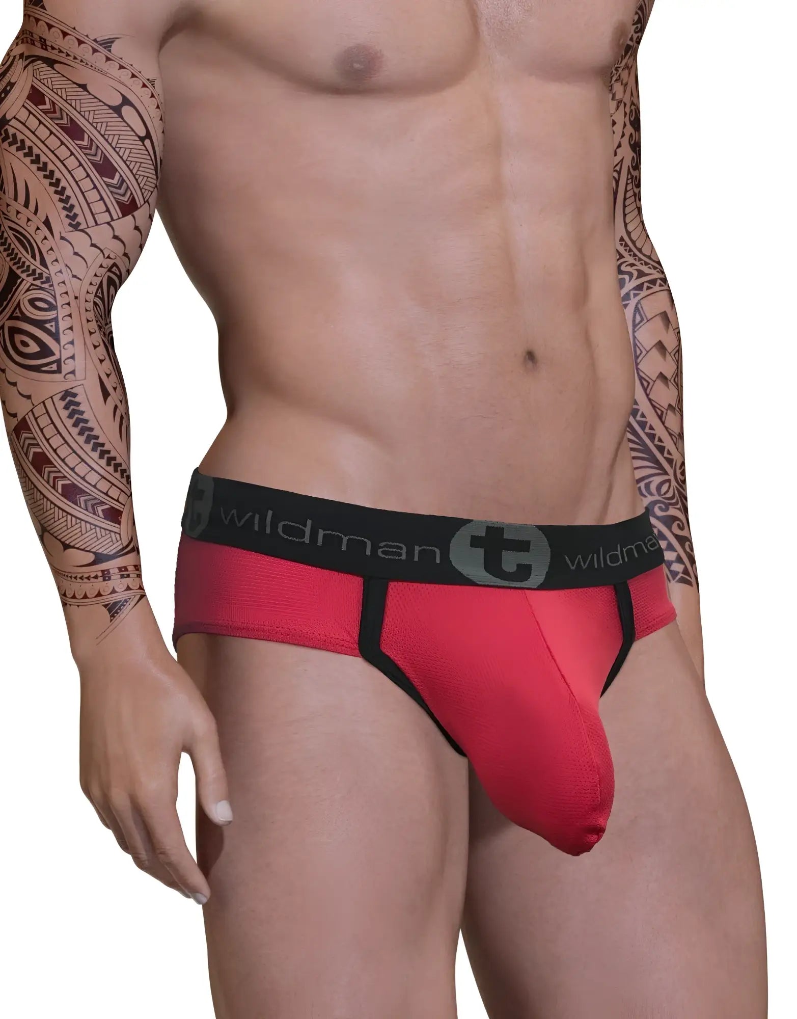 WildmanT red mesh Big Boy pouch brief with black trim and a branded black elastic waistband on a tattooed model.