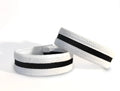 Two white and black elastic slim cock rings with stitched detailing, set against a plain white background.