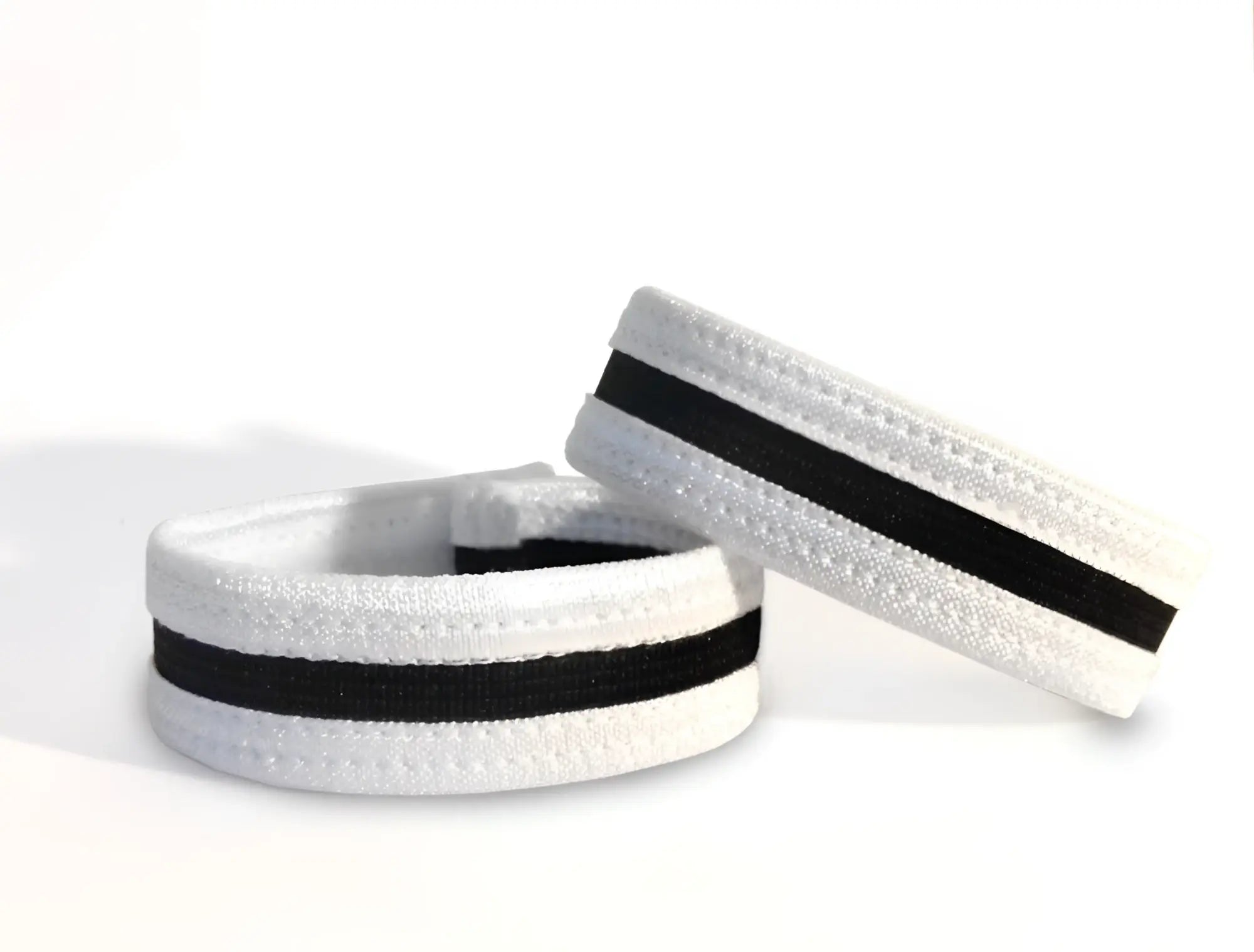 Two white and black elastic slim cock rings with stitched detailing, set against a plain white background.