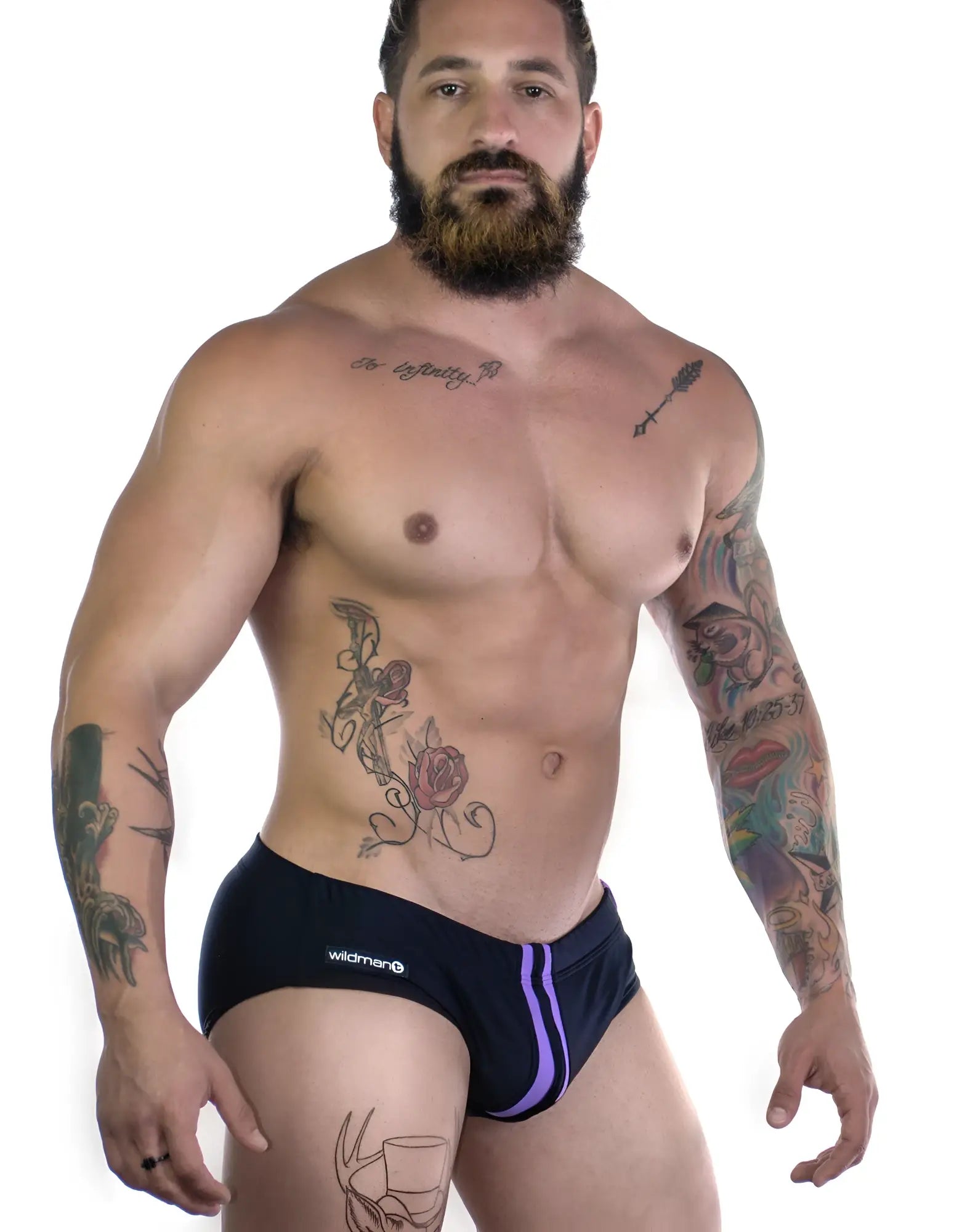 Sportivo bikini in black with a dual purple vertical stripe detail and a Wildman logo patch on the side.
