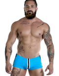 Sportivo Square Cut Teal: vibrant blue square-cut swim trunks with a white and black center vertical stripe.