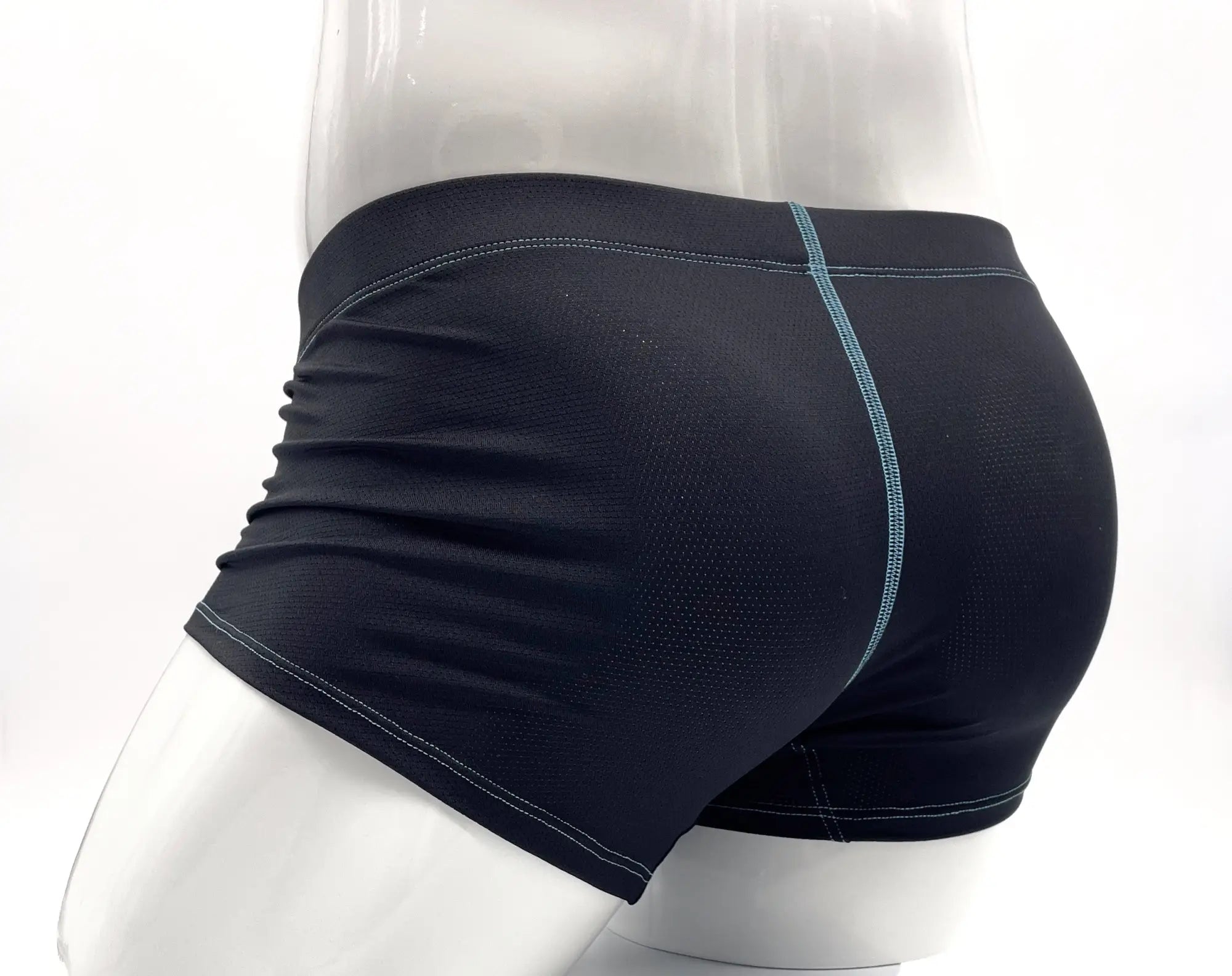 Black performance mesh boxer briefs on a mannequin, featuring teal contrast stitching and a snug, athletic fit.