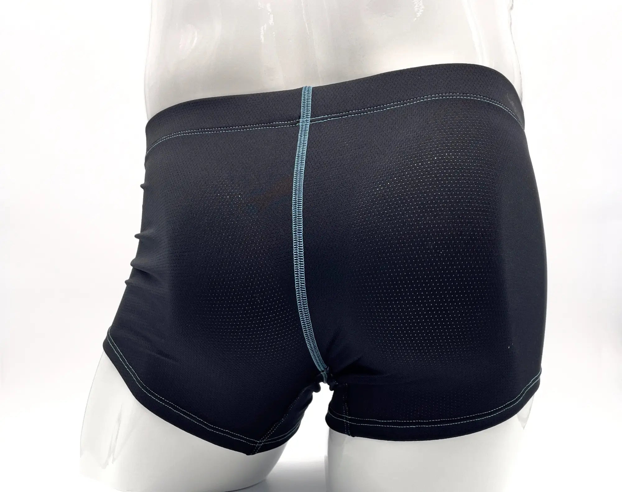 Dark blue, perforated fabric boxer briefs on a mannequin with contrasting light blue stitching detail.