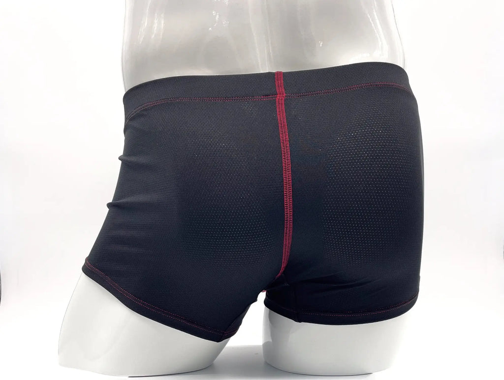 Black mesh boxer briefs with red contrast stitching on a mannequin torso.