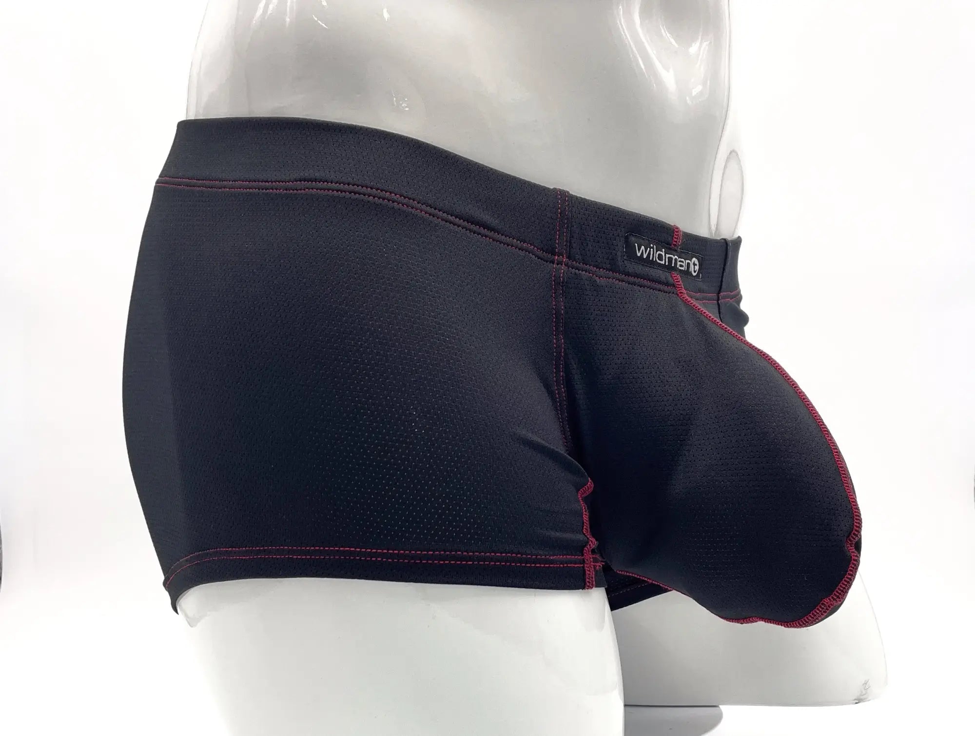 Black perforated boxer briefs with a front pouch and contrasting red stitching, worn on a white mannequin.