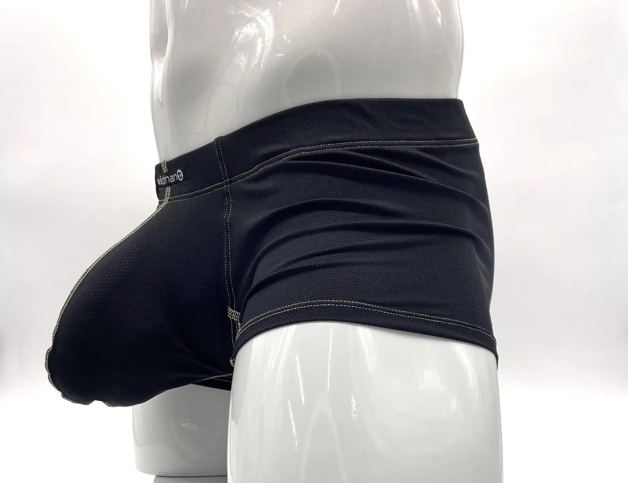 Black pouch boxer briefs with yellow stitching on a white mannequin.